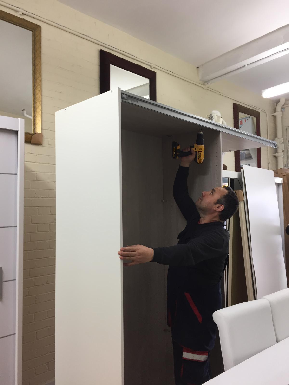 Mehmet fitting a wardrobe